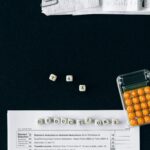 Top-down view of tax deduction items on a black background with a calculator and forms, emphasizing financial planning.